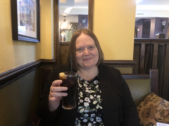 Me holding a drink at Pesto Cabbage Hall